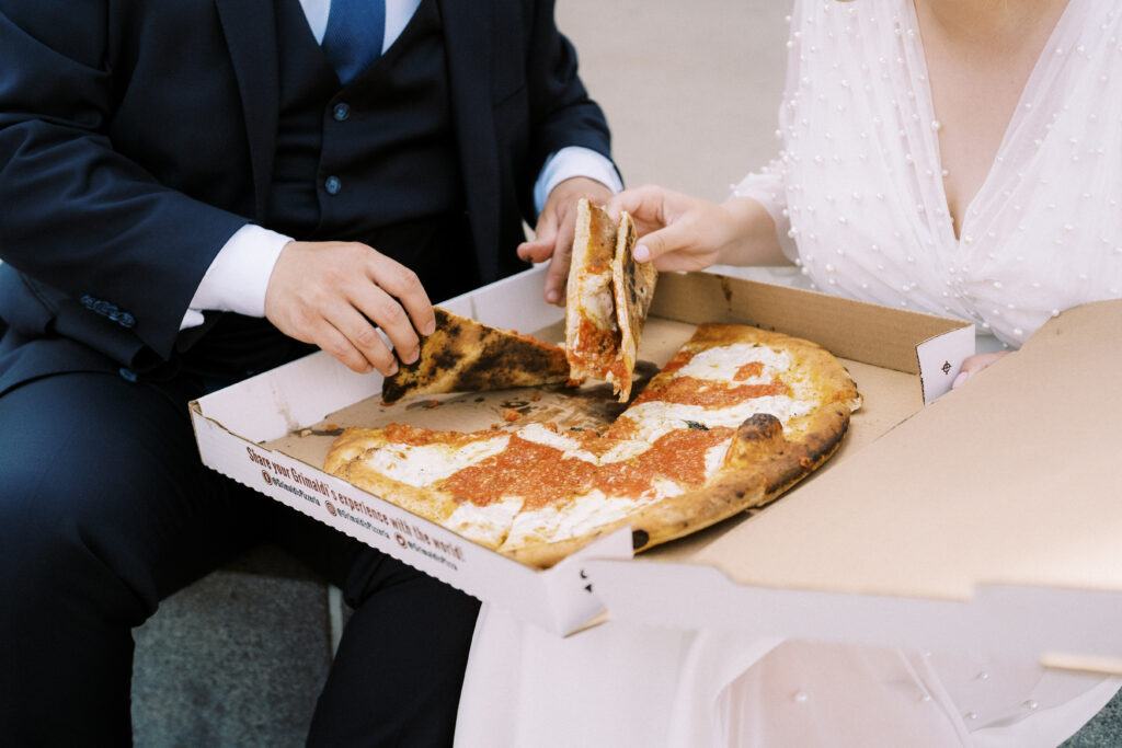 Bride and Groom eating pizza on wedding day in Brooklyn
