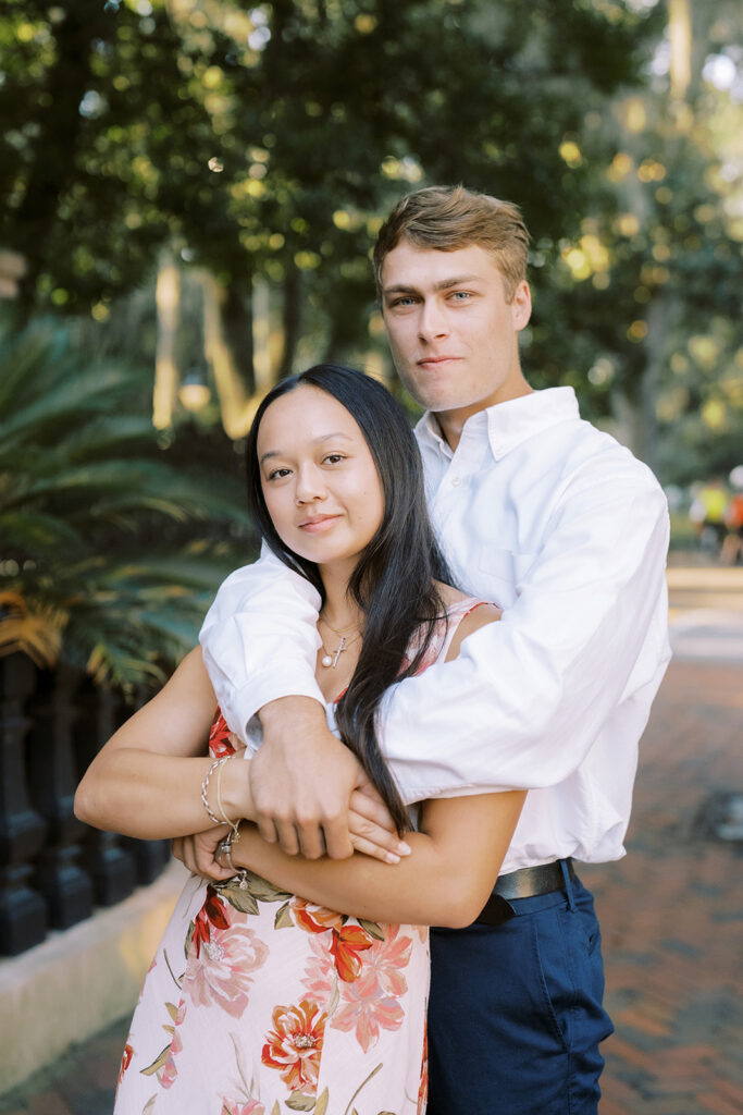 Couple hugging on the sidewalk