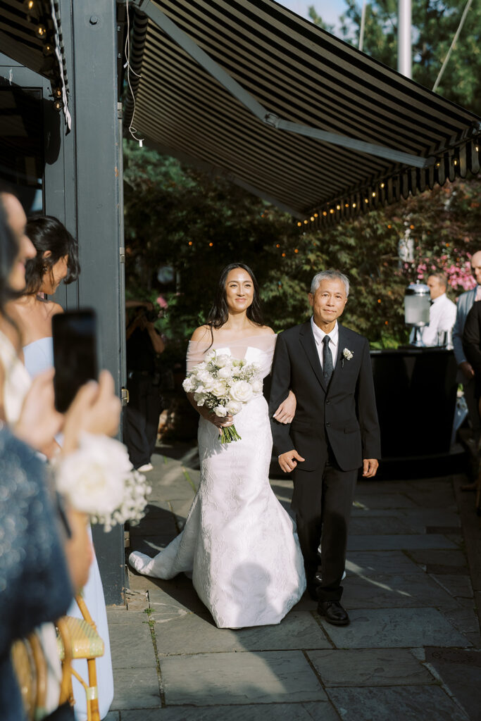 Bride walking down the aisle at the River Cafe