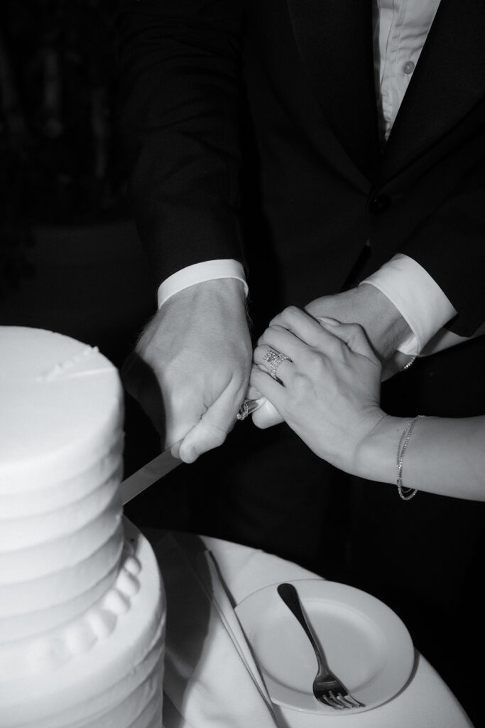 Couple cutting cake at their reception at the River Cafe in Brooklyn